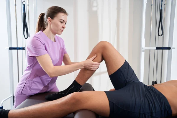 Woman Professional Masseuse Massaging Male Leg While Man Lying Massage — Stockfoto
