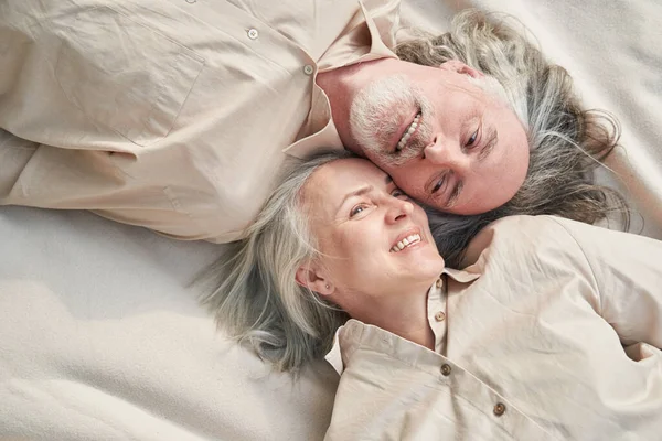 Delighted mature people expressing positivity while spending weekend together outdoors