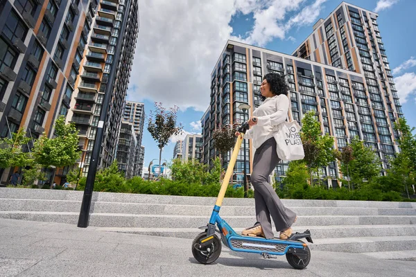 Happy Woman Eco Scooter Backdrop High Rise Buildings — 图库照片