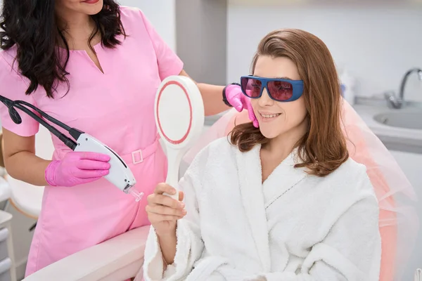 Smiling Woman Enjoying Reflection Mirror While Doctor Completed Professional Cosmetology — Photo