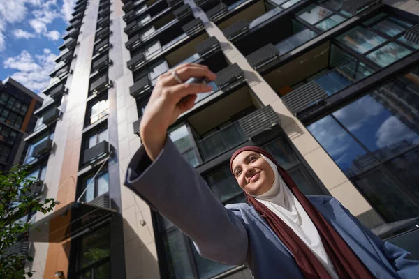 Smiling Woman Hijab Jacket Taking Selfie Front High Rise Building — Stok fotoğraf