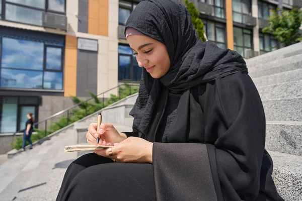 Young Muslim Woman Sitting Stairs Writing Notebook — 스톡 사진