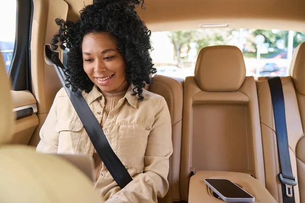 Curly Haired Passenger Actively Texting Laptop Back Seat Comfortable Car — 스톡 사진