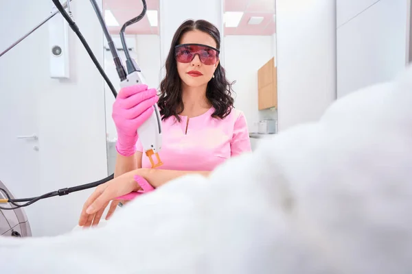 Calm Doctor Removes Hair Female Arm Laser While Goggles Her — Fotografia de Stock