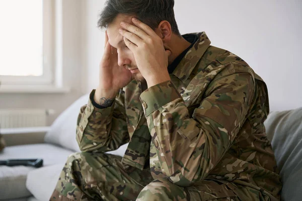 Ukrainian Military Man Grabbing His Head While Sitting Couch While — 图库照片