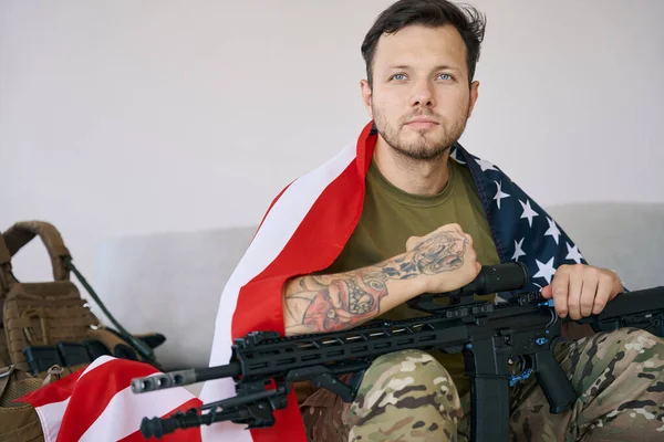 Sbíraný Voják Vlajkou Usa Ramenou Držící Pušku Kolenou Zatímco Ukazuje — Stock fotografie