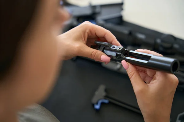 Young Woman Holds Black Technical Detail Her Sleek Hands — Stockfoto