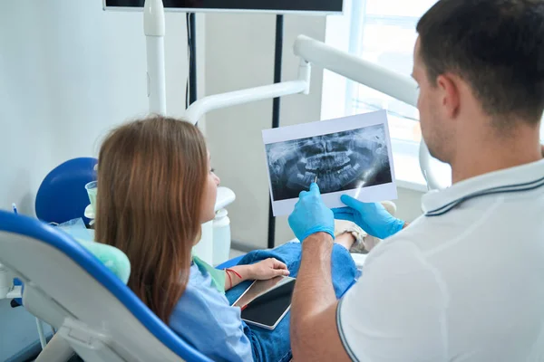 Qualified Doctor Showing Carious Cavity Panoramic Ray Girl Seated Chair — Foto Stock