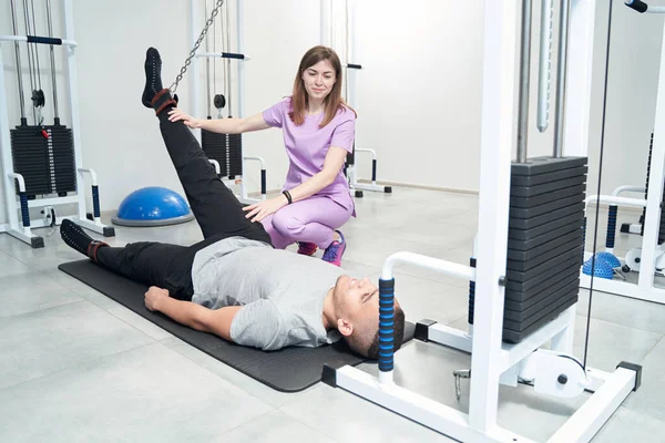 Male Patient Lying Exercise Mat Using Medical Equipment While Doing — Zdjęcie stockowe