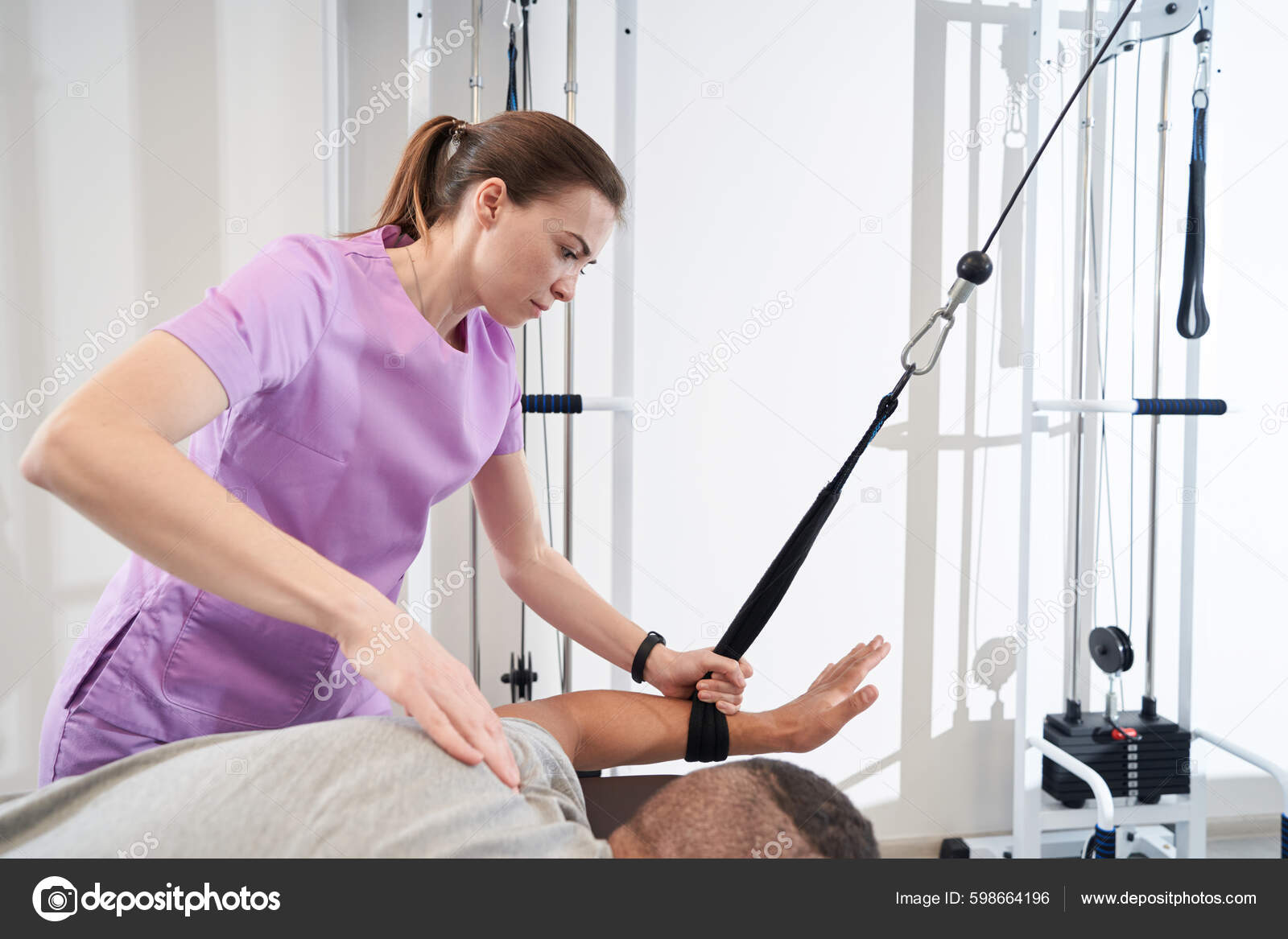 Man Using Kinesiotherapy Training Equipment While Doing Rehabilitation