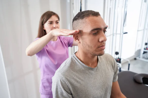 Woman Medical Worker Keeping Hands Man Ears While Performing Face — 스톡 사진