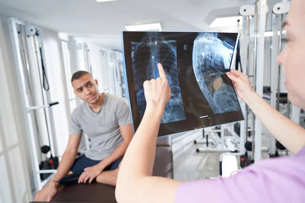 Woman Physician Pointing Radiography Scan While Discussing Examination Results Treatment — Stock fotografie