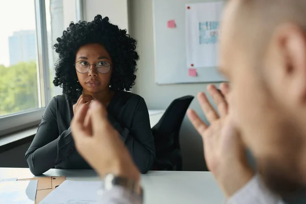 Confused Young Multiracial Female Manager Glasses Sits Table Office Communicates — Stok fotoğraf