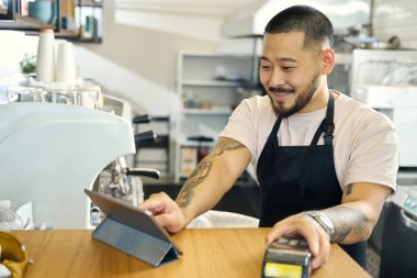 Friendly coffee shop worker making a receipt and offering a payment opportunity via terminal