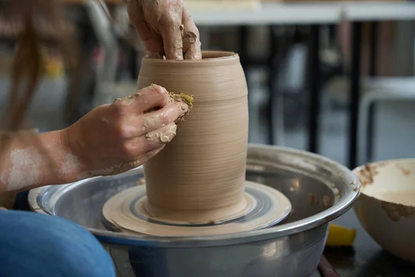 Process of making a clay product on a potter wheel in an art studio