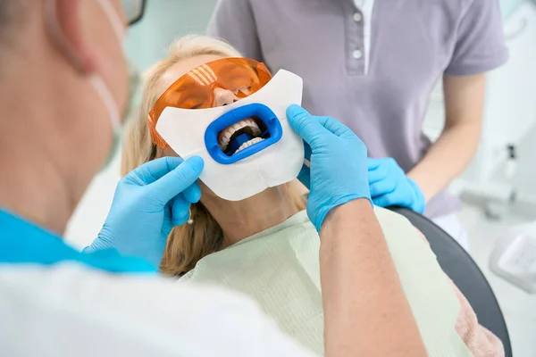 Zamknij Portret Pacjentki Krześle Lekarskim Podczas Gdy Lekarz Przygotowuje Zęby — Zdjęcie stockowe