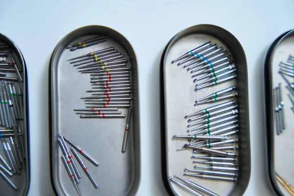 Horizontal photo of metal containers for sterilization with cutters for a drill. dental clinic