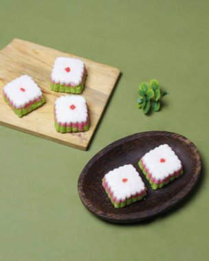 Putu Ayu keki üç renk içeren bir kutu şeklinde, yani yeşil, kırmızı ve beyaz. Bu pastanın yumuşak ve yumuşak bir dokusu var. Putu Ayu marketlerde ya da dükkanlarda bulunabilir. Market atıştırmalıkları. Odak bulanıklığı.