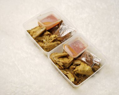 Endonezya baharatlı tavuk. Tavuk parçaları kızartılmaya hazır. Biber soslu, kutuda hazır yiyecekler vb. Şablon için yiyecek paketleme kutusu. Odak bulanıklığı.