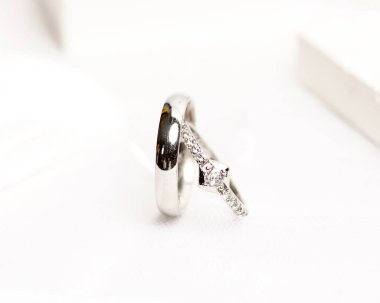 Sosyal medya gösterisi için elmas mücevher yüzüğü. Alyans beyaz taşın üzerinde fotoğraflandı. Mücevher taşlı nişan yüzüğü. Alyanslar parlak beyaz bir arkaplanda izole edilmiş, bulanık odaklı. Altın yüzük..