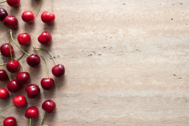 Bej arkaplanda olgun kiraz çilekleri ve metin için yer var. Üst Manzara. Yemek konsepti. Boşluğu kopyala