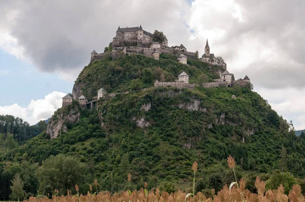 Hochosterwitz Castle on a high wooded hill in Carinthia, Austria. View of the main castle building, fortifications, protective walls and the church tower.