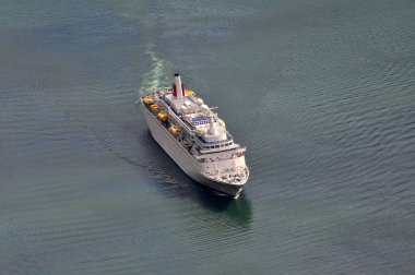 Turistlerle dolu büyük bir yolcu gemisi denizde yelken açıyor..