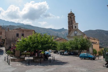 The main square, old stone houses and church tower in the mountain town of Speloncato on the island of Koriska in France.