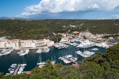 Bonifacio, Italy - 130 August 2012: Harbor and waterfront with ships and yachts moored at sea in the town of Bonifacio on the island of Corsica in France.