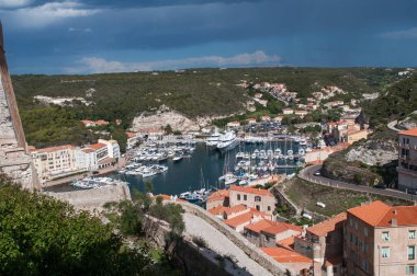 Bonifacio, Italy - 130 August 2012: Harbor and waterfront with ships and yachts moored at sea in the town of Bonifacio on the island of Corsica in France.