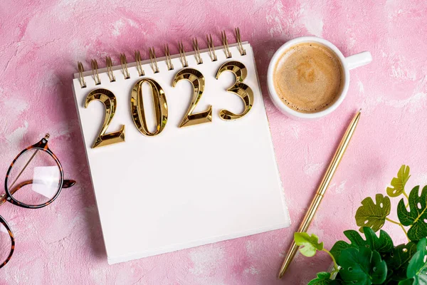 New year resolutions 2023 on desk. 2023 resolutions list with notebook, coffee cup on table. Goals, resolutions, plan, action, checklist concept. New Year 2023 template, copy spac