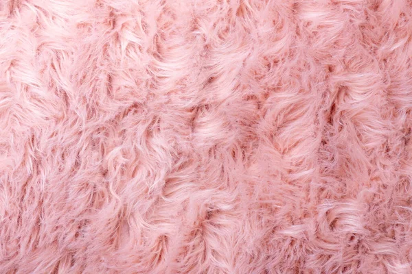 Pink fur texture top view. Pink sheepskin background. Fur pattern. Texture of pink shaggy fur. Wool texture. Sheep fur close u