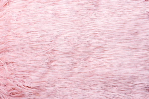 Trendy pink artificial fur texture. Fur pattern top view. Pink fur background. Texture of pink shaggy fur. Wool texture. Flaffy sheepskin close u