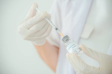 A doctor or scientist is holding a vaccine vial for monkeypox or clade.