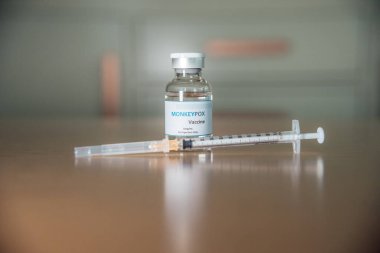 A vaccine vial for monkeypox and a syringe.