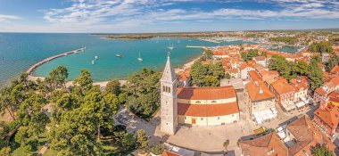 Hırvatistan 'ın kıyı kenti Novigrad' ın çatıları üzerinde gündüz vakti limanı ve kilisesi olan insansız hava aracı panoraması