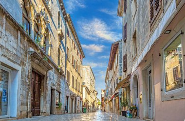 Hırvatistan 'ın kıyı kenti Porec' in yaz güneşinin doğuşu sırasındaki sabah güneşindeki tarihi merkezinin görüntüsü