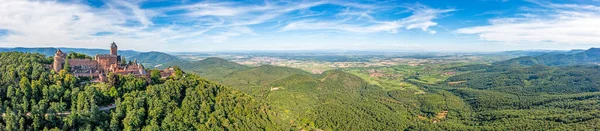 Drone panorama over Rhine plain in Alsace with historical castle during daytime in summer