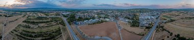 Drone panorama over German settlements Ingelheim and Gau-Algesheim in Rhineland-Palatinate in the evening at sunset