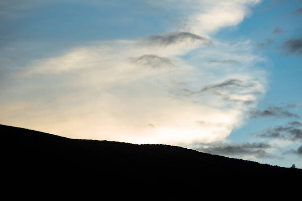 Image of a mountain in the Peruvian Andes. High mountain in Cusco, Peru. Andes in the afternoon with cloudy sky.