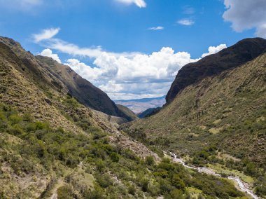 Aerial view of landscapes of Chupani village in middle of the Peruvian Andes. Small community in the Sacred Valley with some ruins and river.