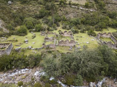 Aerial view of landscapes of Chupani village in middle of the Peruvian Andes. Small community in the Sacred Valley with some ruins and river.