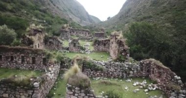Aerial view of landscapes of Chupani village in middle of the Peruvian Andes. Small community in the Sacred Valley with some ruins and river.