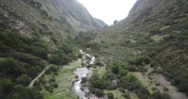 Aerial view of landscapes of Chupani village in middle of the Peruvian Andes. Small community in the Sacred Valley with some ruins and river.