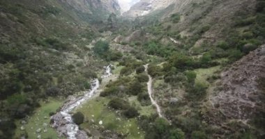 Aerial view of landscapes of Chupani village in middle of the Peruvian Andes. Small community in the Sacred Valley with some ruins and river.
