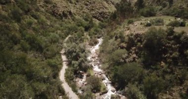 Aerial view of landscapes of Chupani village in middle of the Peruvian Andes. Small community in the Sacred Valley with some ruins and river.