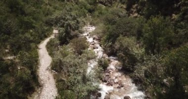 Aerial view of landscapes of Chupani village in middle of the Peruvian Andes. Small community in the Sacred Valley with some ruins and river.