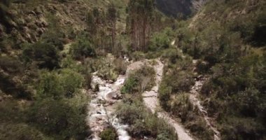Aerial view of landscapes of Chupani village in middle of the Peruvian Andes. Small community in the Sacred Valley with some ruins and river.