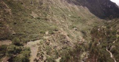 Aerial view of landscapes of Chupani village in middle of the Peruvian Andes. Small community in the Sacred Valley with some ruins and river.