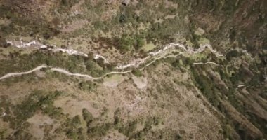 Aerial view of landscapes of Chupani village in middle of the Peruvian Andes. Small community in the Sacred Valley with some ruins and river.